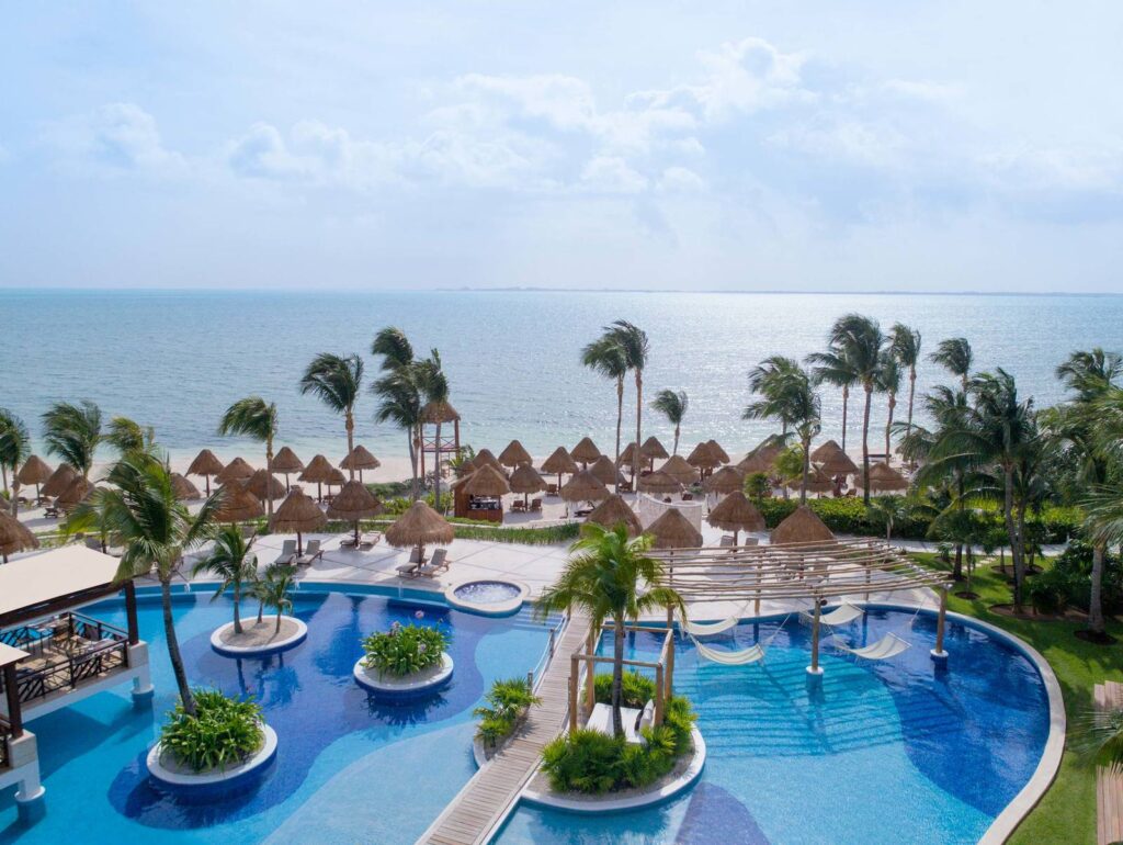 All inclusive beach resorts with ocean view, pool, and palm trees