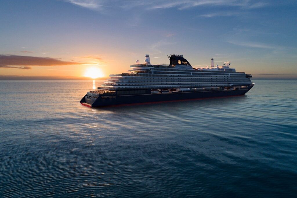 Luxury ship sailing past a sunset